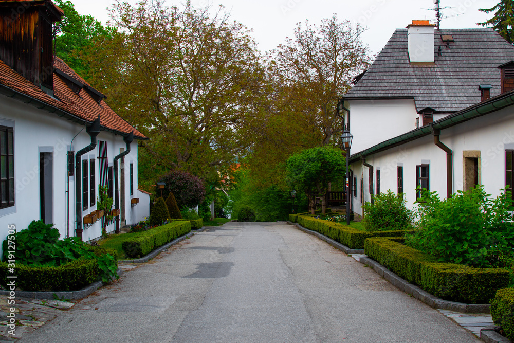 Sidewalk between white typical houses in the Castle Gardens in Cesky Krumlov, Czech Republic