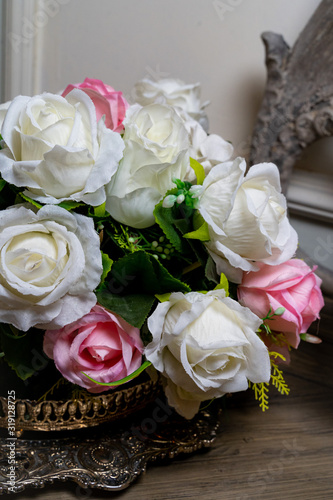 Bouquet of white and red roses in a vase on the table.