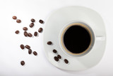 White cup with coffee on a white background and coffee beans