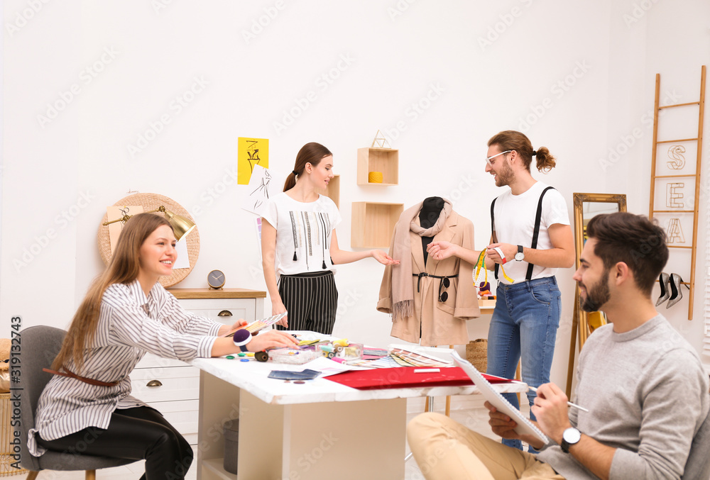 Fashion designers creating new clothes in studio Fashion designers creating new clothes in studio