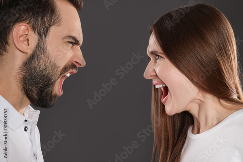 Couple quarreling on black background, closeup. Relationship problems
