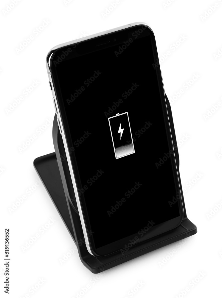 Mobile phone charging with wireless pad isolated on white Mobile phone charging with wireless pad isolated on white