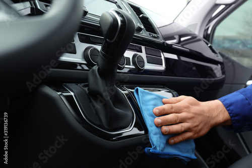 Car wash worker cleaning automobile interior, closeup © New Africa