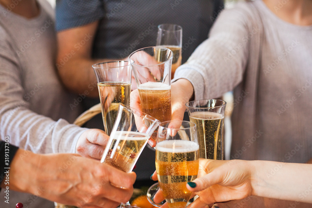 People's hands with glasses of champagne, celebrating a holiday, salute, holiday and birthday