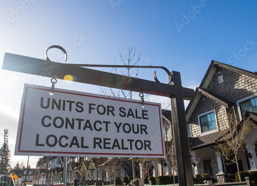 Units for sale contact your local realtor sing. In front of a house in a residential neighborhood.