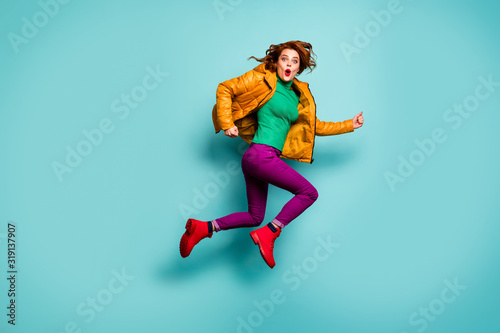 Full length photo of funny fast speed lady jump high rush sale shopping center cool prices wear yellow coat scarf magenta pants turtleneck red boots isolated teal color background