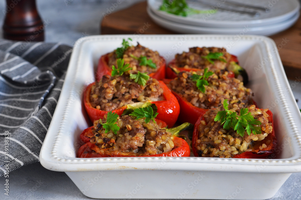 Baked paprika with meat on a concrete background.