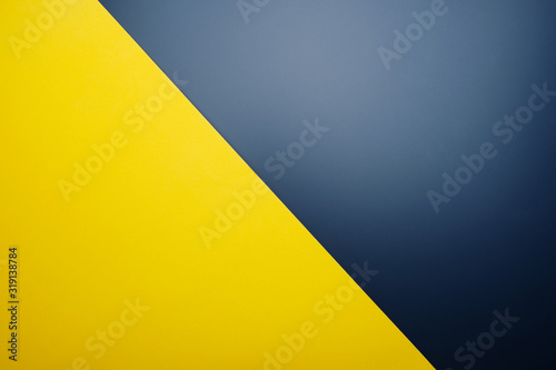 Yellow paper on black table color with light spot for background.