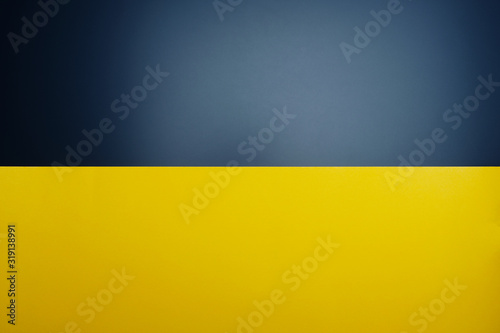 Yellow paper on black table color with light spot for background.