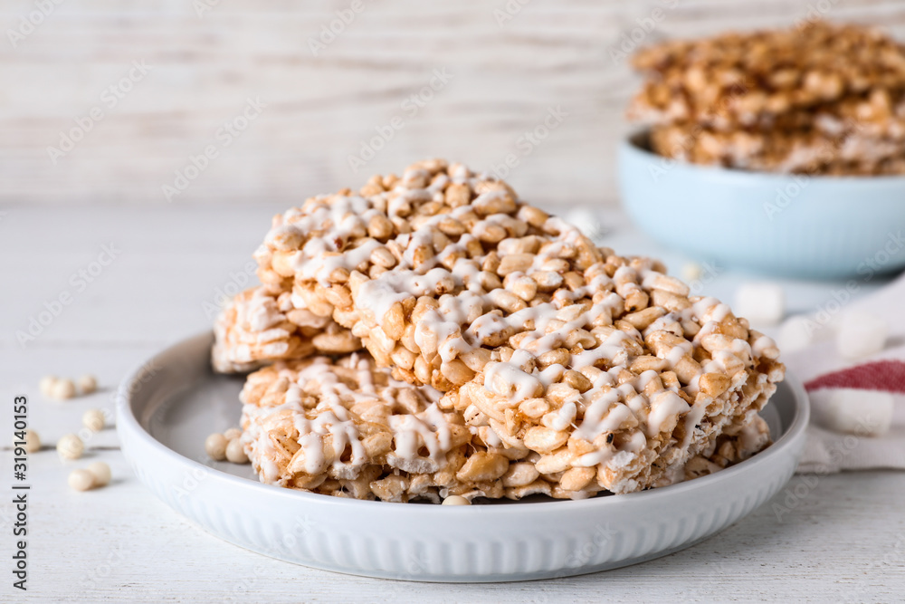 Delicious rice crispy treats on white wooden table, closeup Delicious rice crispy treats on white wooden table, closeup