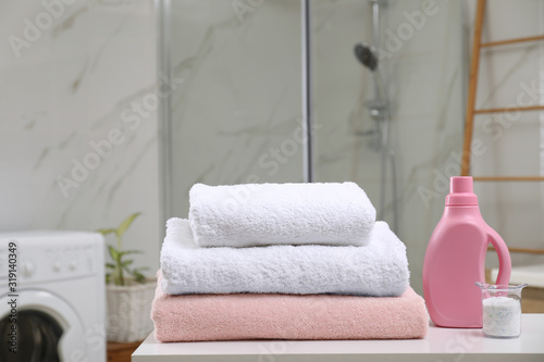 Clean towels and detergents on table in laundry room