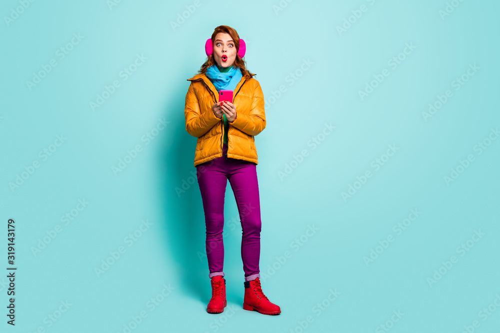 Full size photo of funny traveler lady hold telephone open mouth check followers stupor wear casual yellow overcoat scarf purple pants shoes isolated teal color background Full size photo of funny traveler lady hold telephone open mouth check followers stupor wear casual yellow overcoat scarf purple pants shoes isolated teal color background