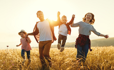 Happy family father of mother and child son  on nature at sunset