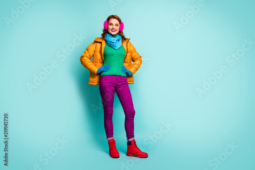 Full length photo of dreamy candid woman enjoy winter autumn holiday put hands waist wear casual shine clothes isolated over turquoise color background