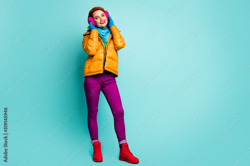 Full body photo of charming cute woman touch her soft warm bright ear covers feel dream dreamy enjoy holidays wear casual style clothes isolated over green color background