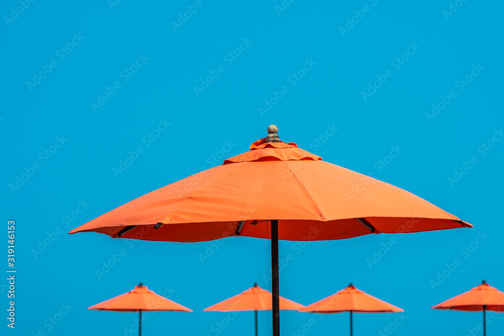 Umbrella with beautiful blue sky background nearly sea ocean beach