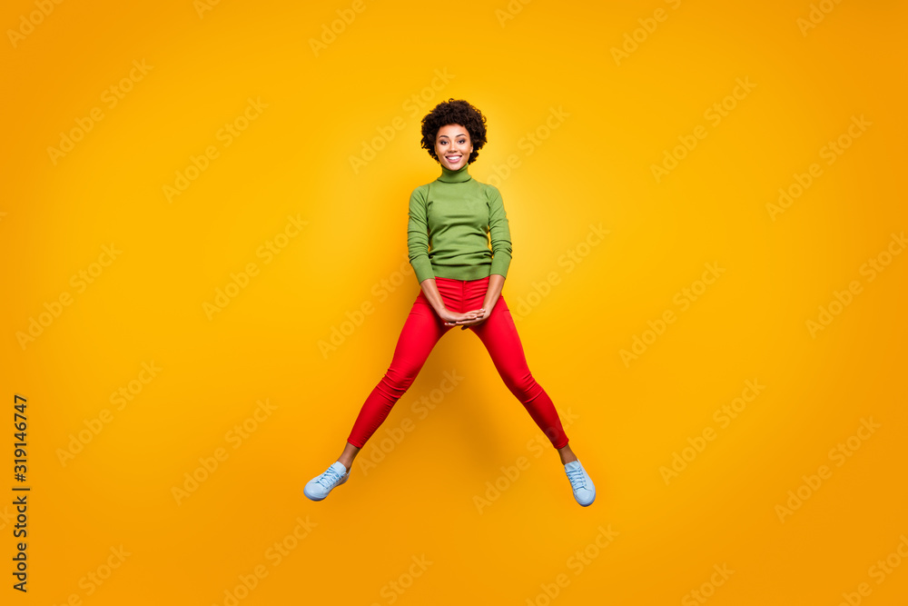 Full length body size view of her she nice attractive lovely cheerful cheery wavy-haired girl jumping having fun fooling isolated over bright vivid shine vibrant yellow color background