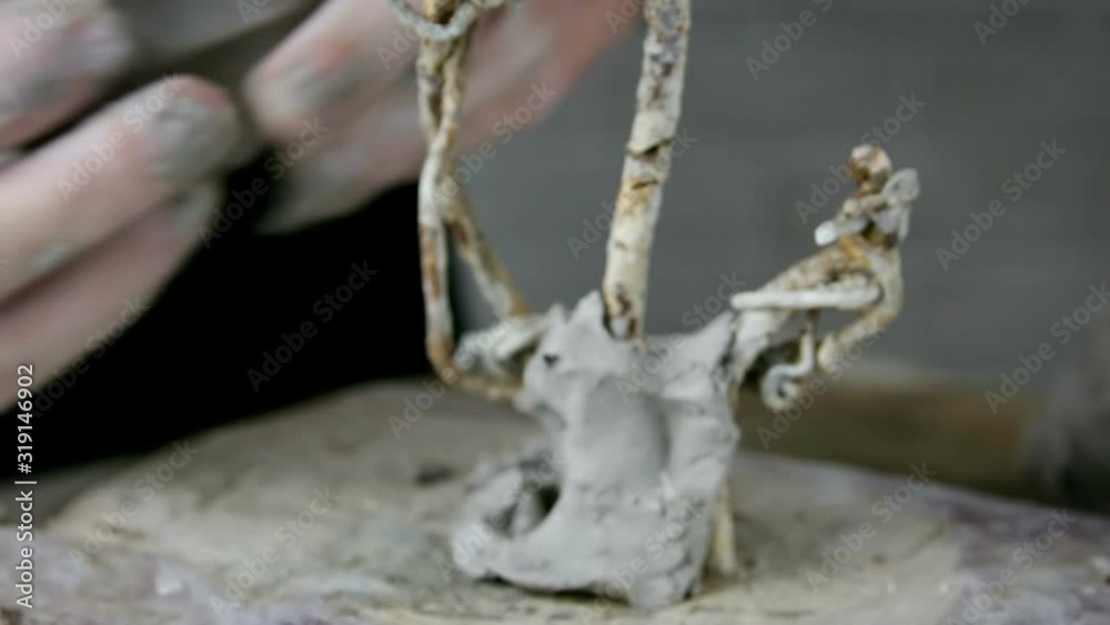 Hands makes a clay sculpture. The sculptor man makes a clay sculpture. Sculptor shapes the clay with hands close up Hands makes a clay sculpture. The sculptor man makes a clay sculpture. Sculptor shapes the clay with hands close up