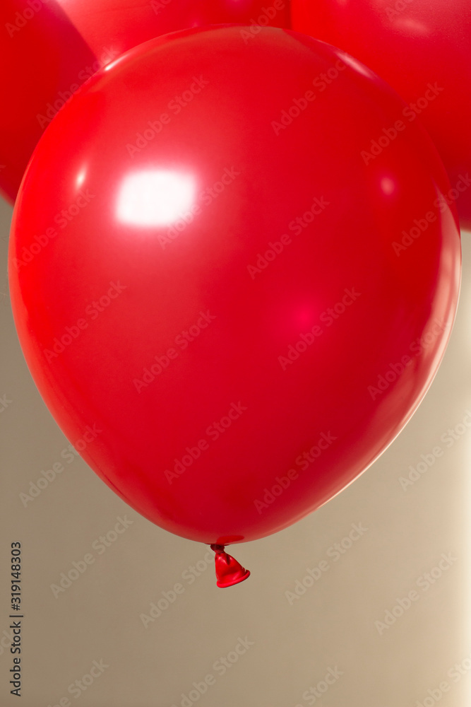 red helium balloons on beige background red helium balloons on beige background