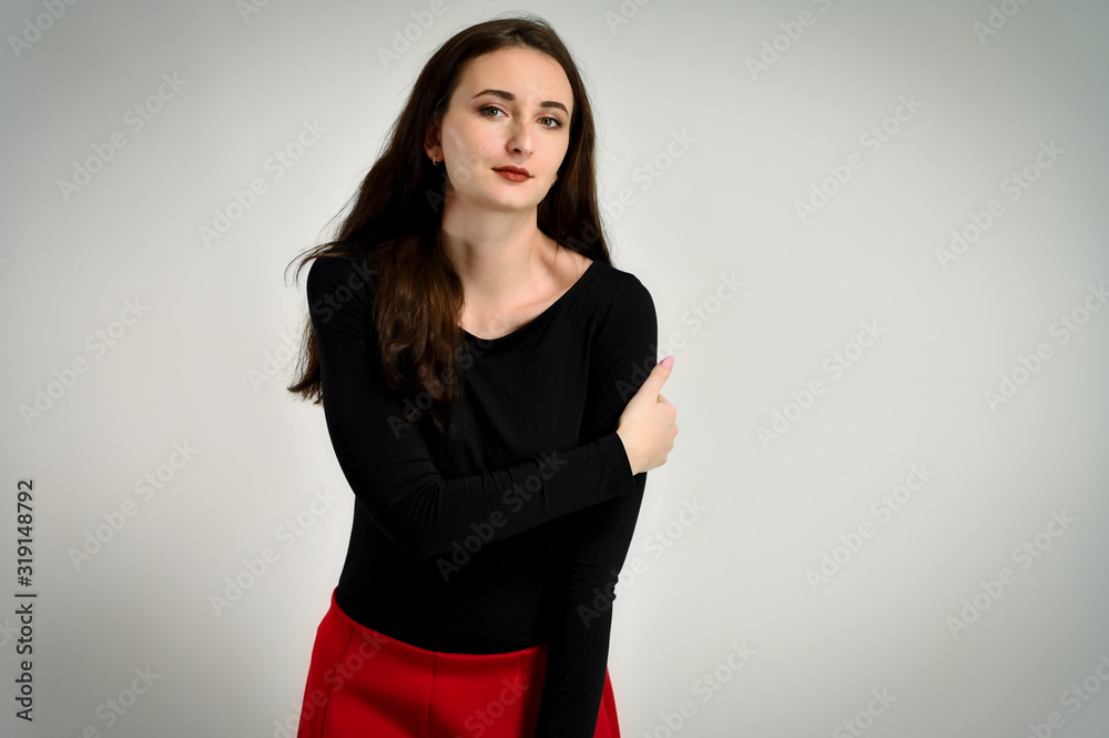 Concept girl talking in front of the camera with emotions. Photo of a pretty young brunette woman with a smile with good makeup on a white background. Concept girl talking in front of the camera with emotions. Photo of a pretty young brunette woman with a smile with good makeup on a white background.