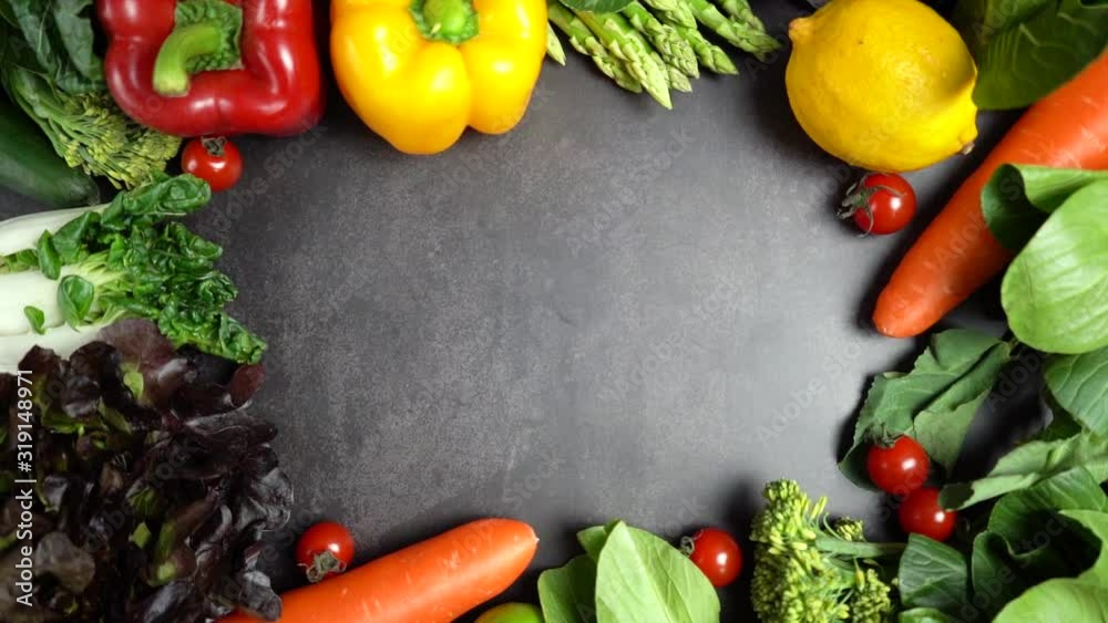 Zoom in border of fresh organic vegetables setting background on table, Healthy food concept top view. Slow motion. Zoom in border of fresh organic vegetables setting background on table, Healthy food concept top view. Slow motion.