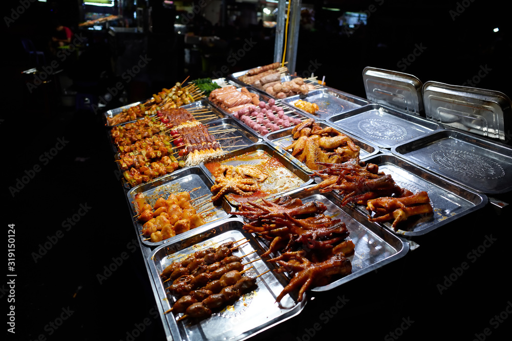 Duong Dong, Phu Quoc island, Vietnam - March 27,2019: A night walk in the city. Street cafes at the night market. Food on the shelves