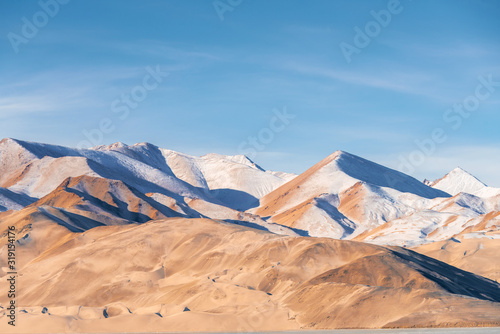 White and yellow sandy mountain with snow covered located in Xinjiang China Tashkurgan(Taxkorgan).