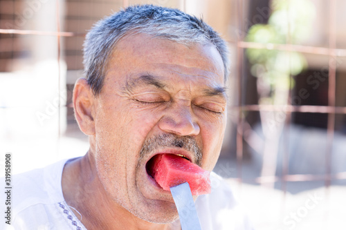 man eating a watermelon with gusto