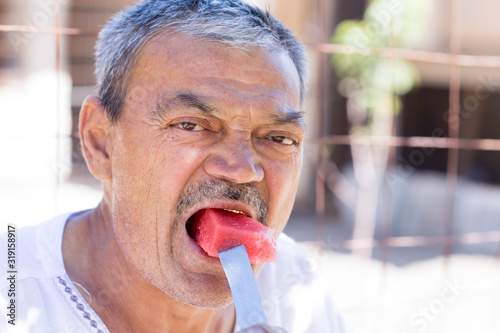 man eating a watermelon with gusto