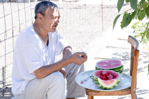 man eating a watermelon with gusto