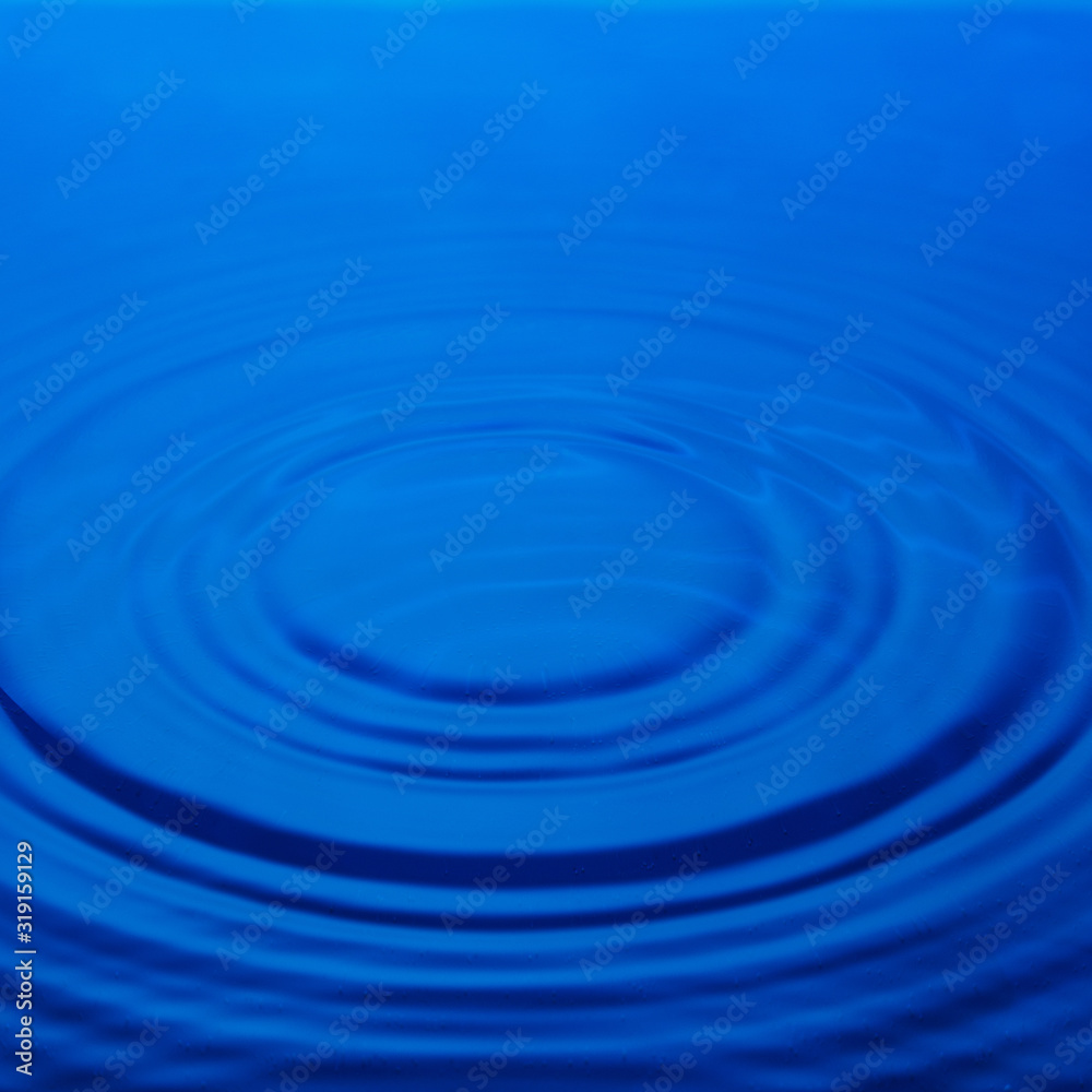 Circles on the water, blue background. Abstraction.