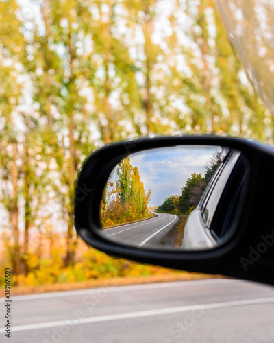 autumn landscape is reflected in the car mirror . cities that go into the distance © Taranova_ksenya