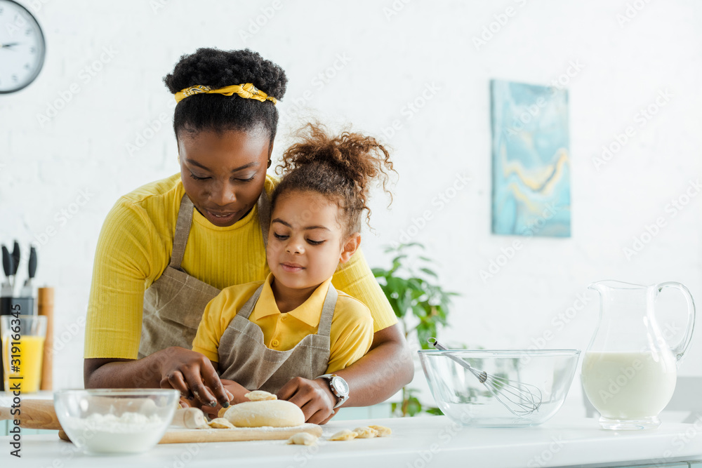 african american mother near adorable kid sculpting dumplings in kitchen african american mother near adorable kid sculpting dumplings in kitchen