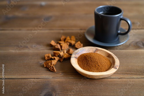 chaga tea mushroom from birch tree using for healing tea or coffee in folk medicine. ground powder