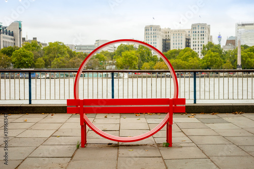 Circle bench on Thames river bank in London, UK photo