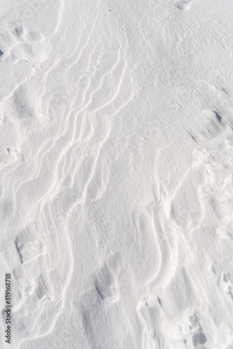 White snow surface texture with soft shadow.