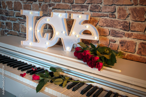Love sign with flowers on a piano
