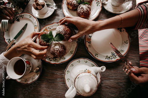 Two girls drink tea in a restaurant with custard buns / big plan