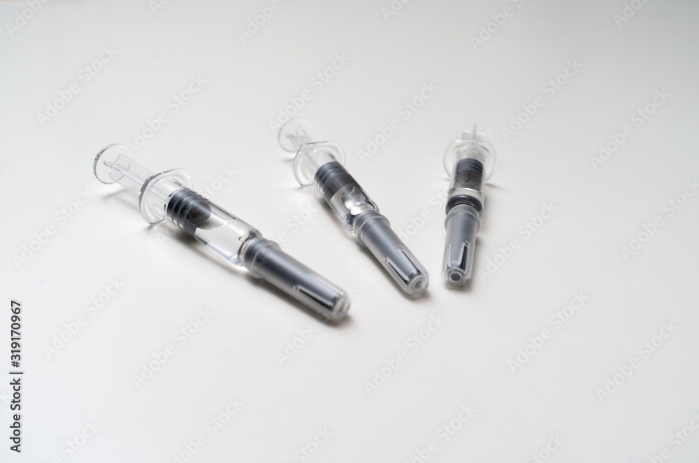 Generic prefilled vaccine syringes. Close-up studio shot. Generic prefilled vaccine syringes. Close-up studio shot.
