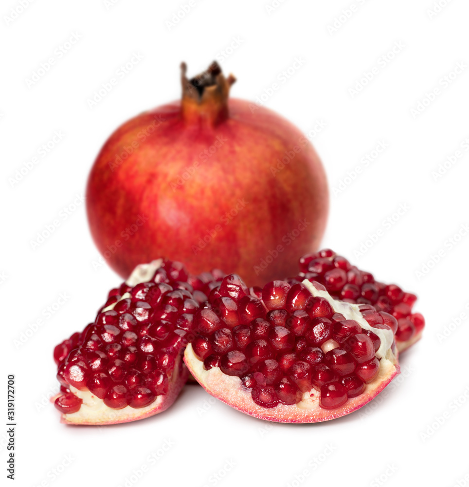 Pomegranates with pomegranate seeds on a white background. Pomegranates with pomegranate seeds on a white background.