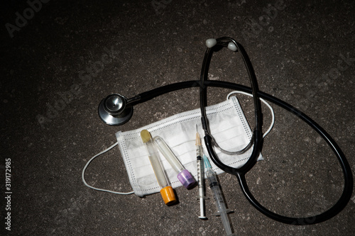 Stethoscope, syringe and face mask  photo