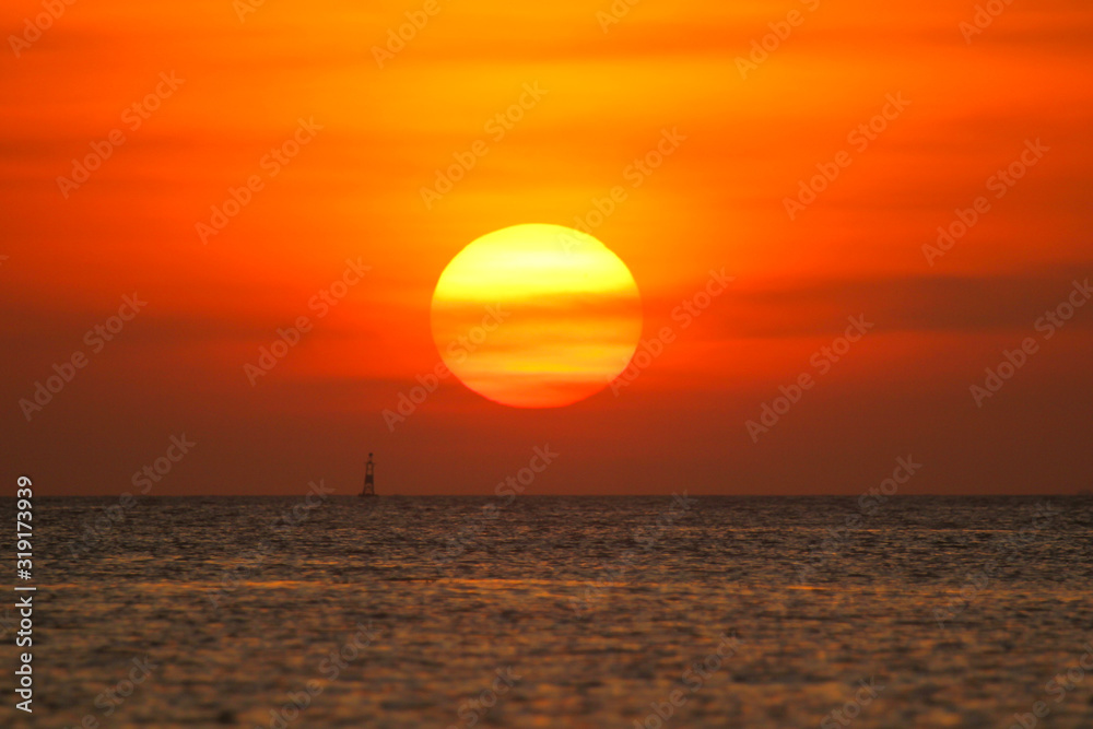Fishing boat in the ocean on a sunset background