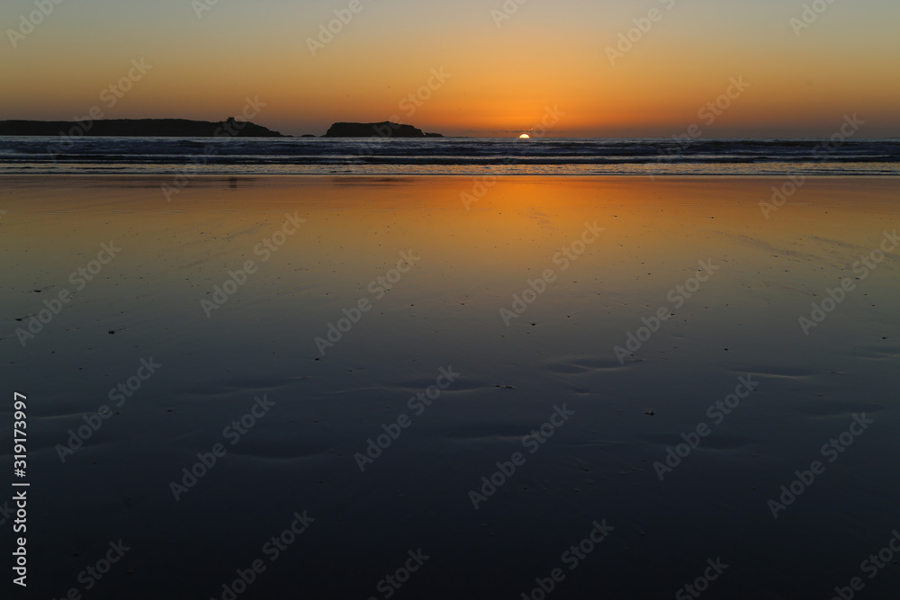 Wet sand at low tide on a sunset background Wet sand at low tide on a sunset background