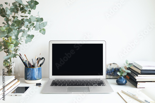 Stylish work space with laptop with blank copy space display for your design, template, information or text. Modern lifestyle, distant job, occupation and electronic gadgets concept. Isolated image