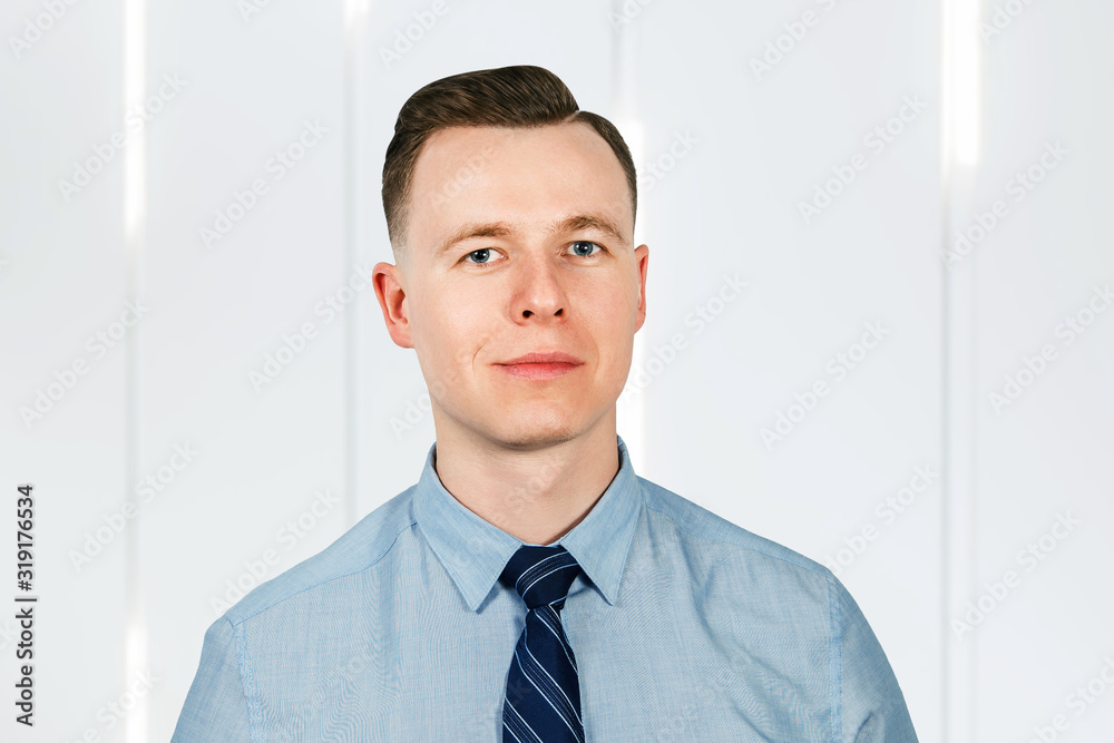 Portrait of young man businessman dressed in blue shirt and tie Portrait of young man businessman dressed in blue shirt and tie