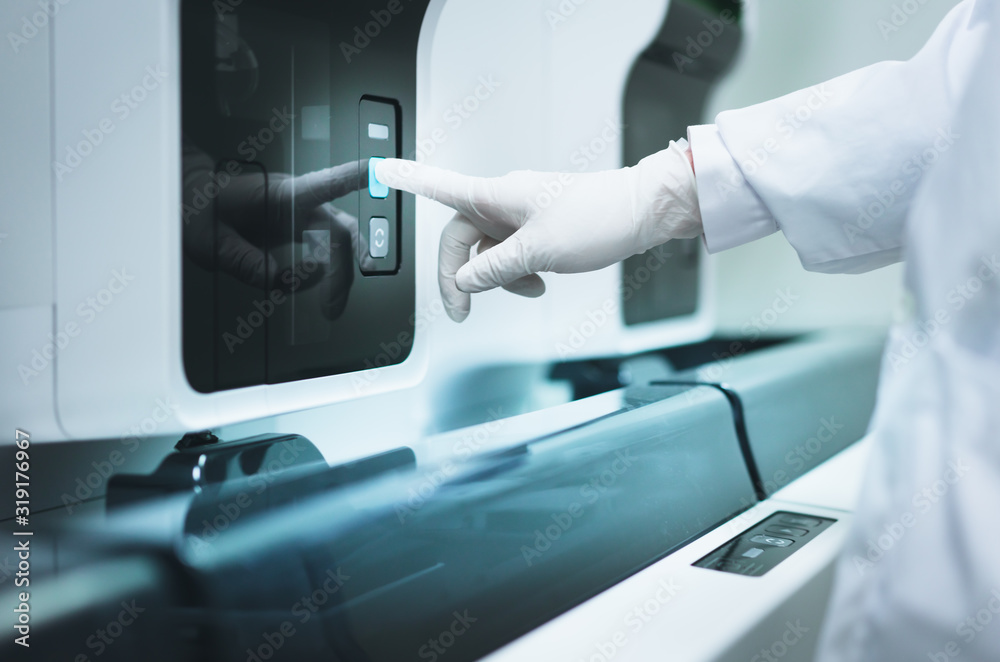 Medical personnel is operating a medical testing equipment Medical personnel is operating a medical testing equipment