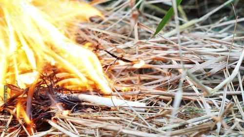 The fire burned on the hay from the cigarette butt.