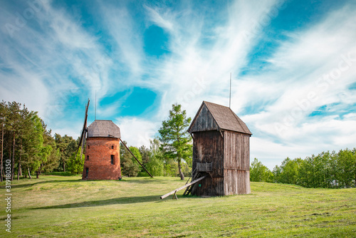 Fototapeta Naklejka Na Ścianę i Meble -  Traditional old polish windmills. Wooden and masonry, Spring, green meadow. 