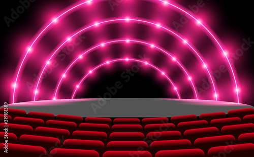 pink neon light on the stage with chair in the hall