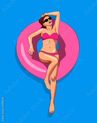 Young woman in a bikini floating on inflatable raft in a pool